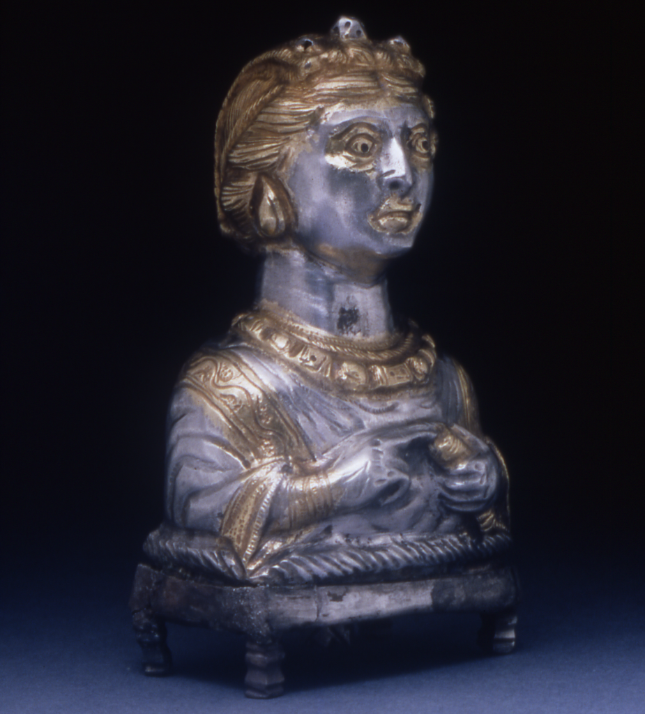 Image shows a hollow silver statuette of the top half of a woman's body.