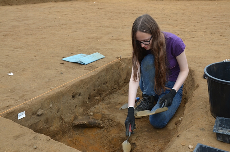girl excavating with a trowel