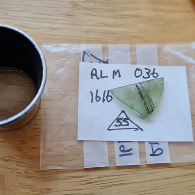 A glass fragment on top of a label and bag