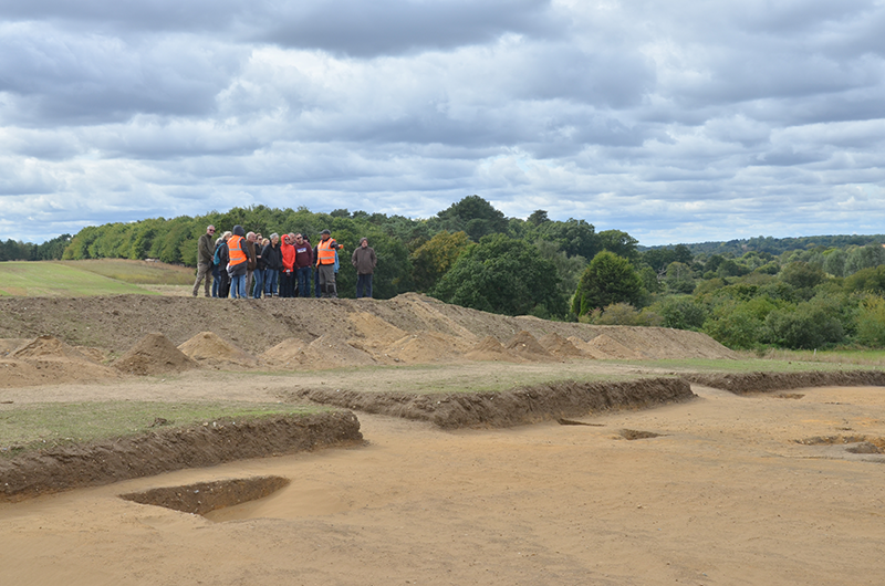 group of people looking at trench
